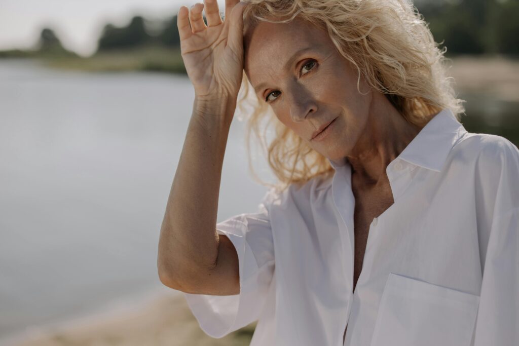 Portrait einer attraktiven Frau mit einem See im Hintergrund -Kollagen ab 50 - Beauty & Anti-Aging